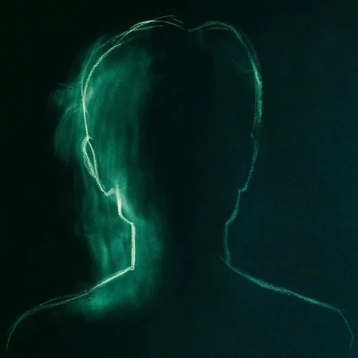 A figure drawn in green chalk, head and shoulders, no face.